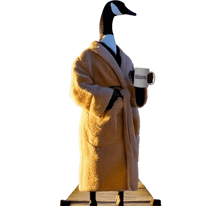 A goose in a robe holding a cup of coffee